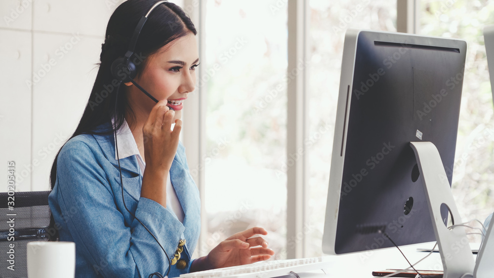 Aufkleber customer support agent or call center with headset works on desktop computer while supporting the cu