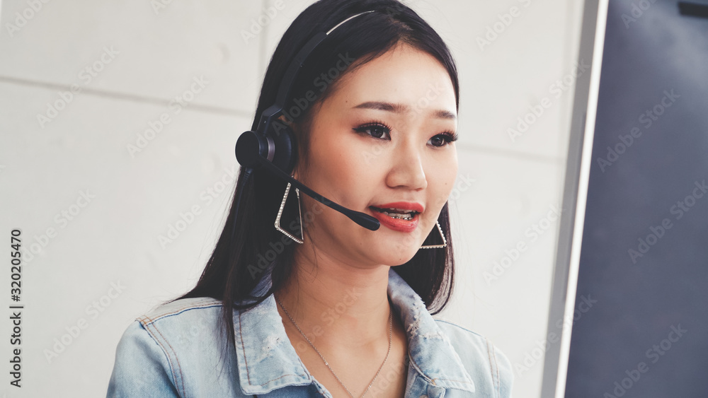 Aufkleber customer support agent or call center with headset works on desktop computer while supporting the cu