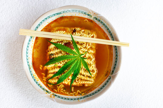 Bowl of instant noodles, chopsticks and cannabis leaves, fast food for breakfast Lunch and dinner