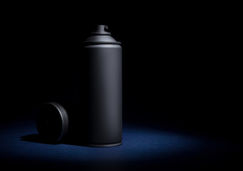 Spray can with spray paint on a black background