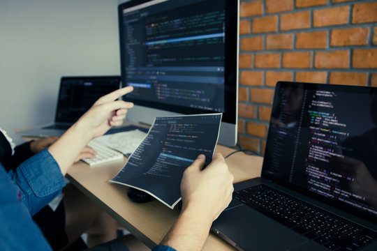 Developing programming and coding technologies working in a software engineers developing applications together in office.