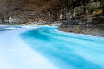 Frozen river in the wild mountains