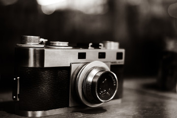 Fototapeta na wymiar Vintage film camera, collectibles. retro photography equipment. Black and White sepia color tone.