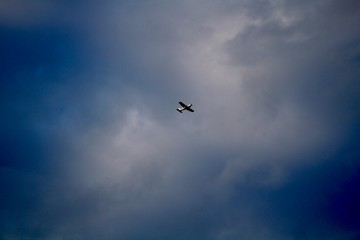 Fototapeta na wymiar Plane flying in stormy weather