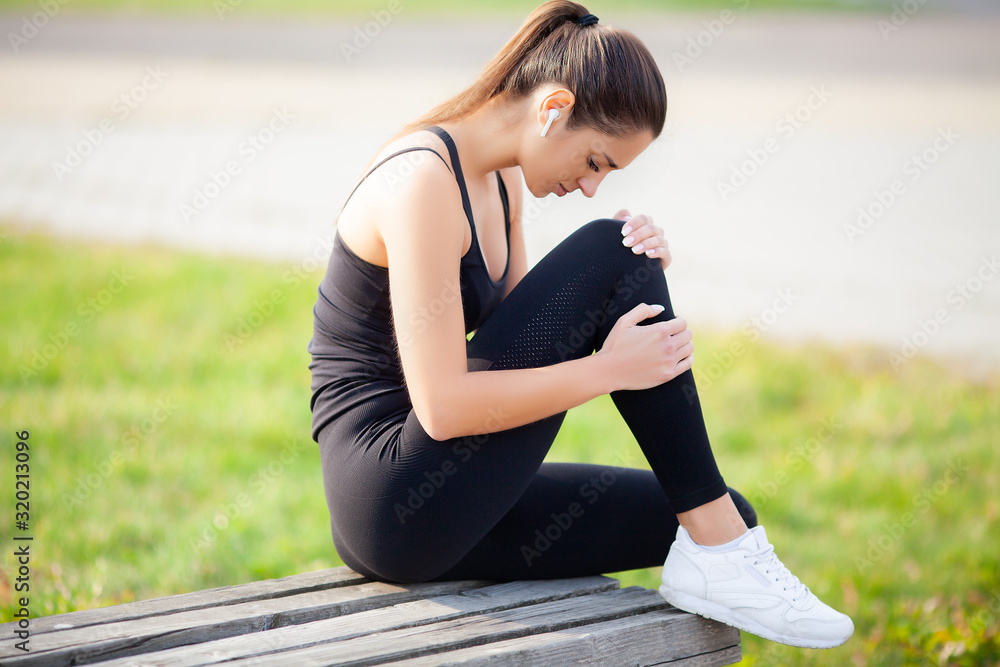 Wall mural Woman Suffering From Pain In Leg After Workout