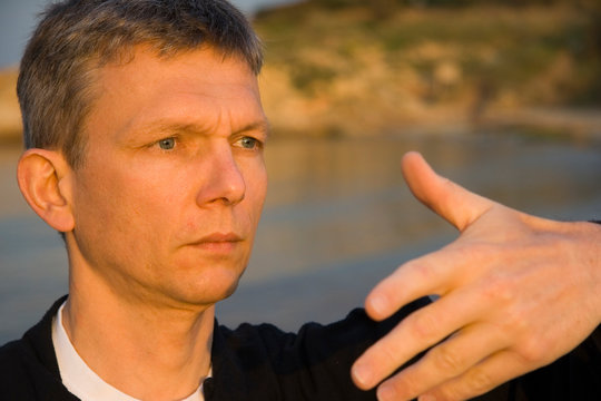 Mature Man Practicing Tai Chi At Beach