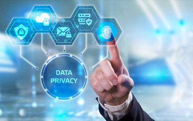 Business, technology, internet and networking concept. Young businessman working  in the office, select the icon Data privacy  on the virtual display.