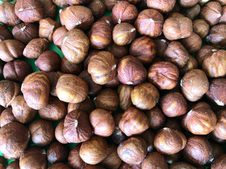 Food background. Hazelnut kernels. A pile of round hazelnuts. The texture of nuts. Close-up, horizontal, top view. The concept of a healthy diet.