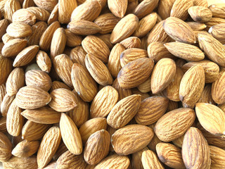 Food background. Yellow almond kernels. Peeled almonds. Texture of dried nuts. Close-up, horizontal, top view. The concept of a healthy diet.