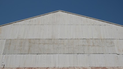 Corrugated zinc facade soars into blue sky