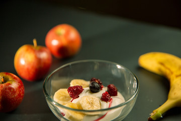 Mature man working at home as a watchmaker and jeweler composing an old clock using a screwdriver and a magnifying glass to be able to see closely