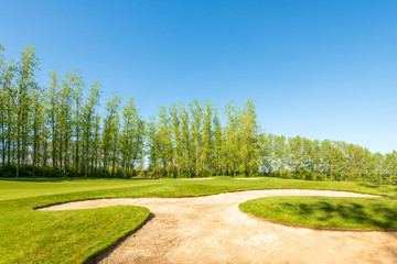 Golf course with gorgeous green and sand bunker