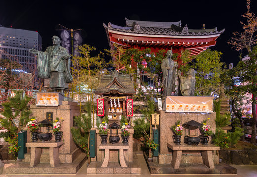 Religious Monuments Of Nichiren Schools Of Buddhism In The Tokudaiji Temple Of Tokyo At Night.