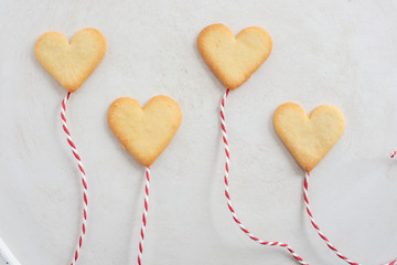 Valentines Day Concept: closeup of fresh baked heart shaped cookies on a table