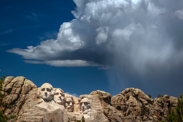 Mount Rushmore National Memorial, four ex Presidents faces sculptured into granite with dramatic stormy sky background, Mount Rushmore, South Dakota, USA