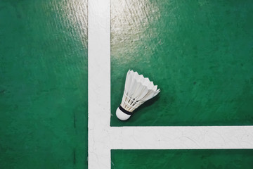 Top view, flat lay of shuttlecock on badminton court. A game with rackets and playing indoor Batminton. selective focus, copy space. Indoor Sport concept.