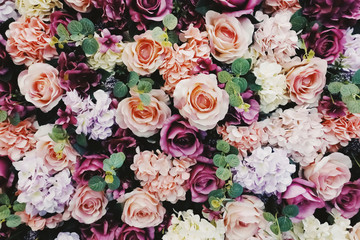 Close up of roses in pink, orange, red and purple hydrangea with green leave background and texture. For wallpaper, background, romance, wedding, presentation, card and floral theme. Horizontal.