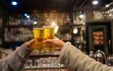 Group of friends celebrating and having drinks in a pub