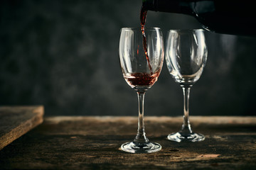 Red wine on wood background..