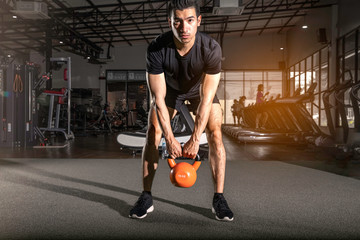 Fitness Kettlebells swing exercise athlete young  man workout at gym