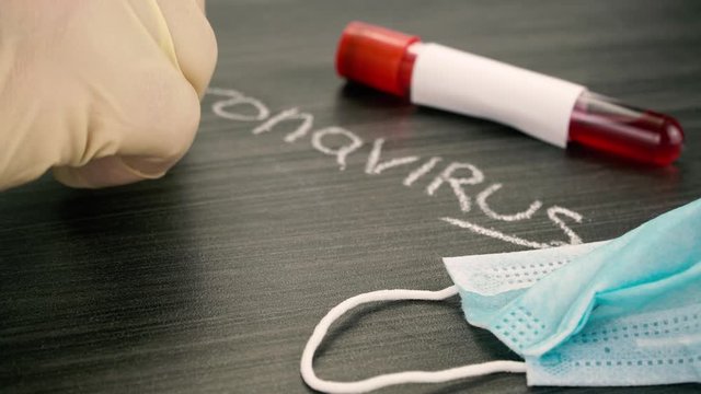 medical protective mask and blood test tube. Concept of coronavirus quarantine. New type coronavirus 2019-nCoV pneumonia in Wuhan has been spreading into many cities in China.
