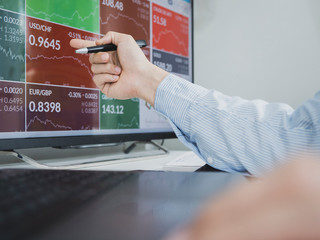 trader use computer explan about  forex and cryptocurrency data and bar chart, invester concept.