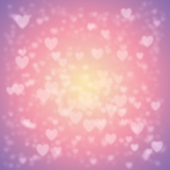 Heart bokeh texture/background/pattern to celebrate Valentine Day. Pastel colors. Yellow, pink, and purple. Falling snow effect. Heart snowflakes.