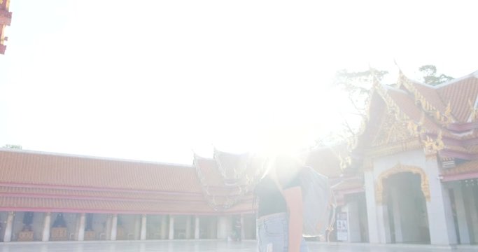 Asian beautiful tourist women walking travel in Mable buddhist temple with backpack in Bangkok city Thailand