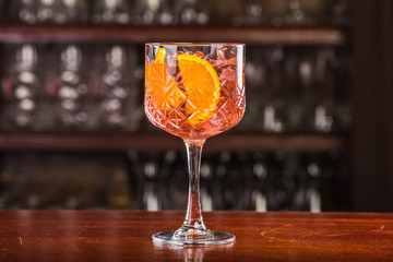Aperol coctail on a wooden stand. 