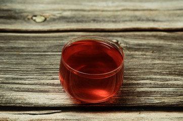 A Cup of hot black tea on wooden table.