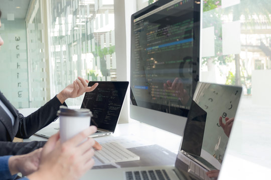 Programmers work on the development of coding and coding technology on white desks and website design, software, data processing companies, servers.