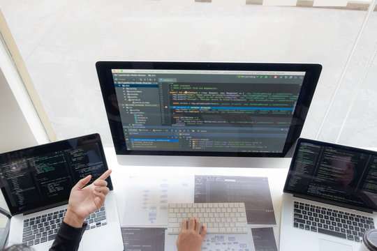 Programmers work on the development of coding and coding technology on white desks and website design, software, data processing companies, servers.