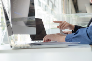 Programmers work on the development of coding and coding technology on white desks and website design, software, data processing companies, servers.