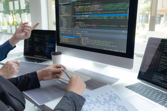 Programmers work on the development of coding and coding technology on white desks and website design, software, data processing companies, servers.