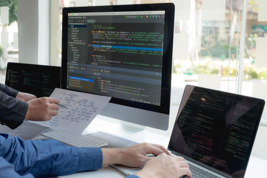 Programmers work on the development of coding and coding technology on white desks and website design, software, data processing companies, servers.