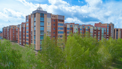 New residential building, with beautiful architecture, which stands among the trees.