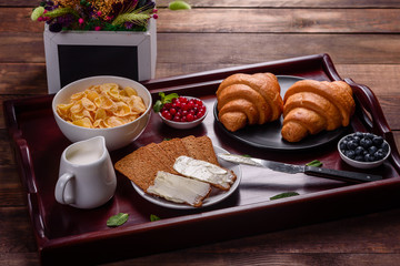 Delicious breakfast with fresh croissants and ripe berries