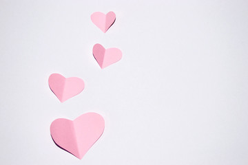 Valentines day background.Pink paper hearts with white background.