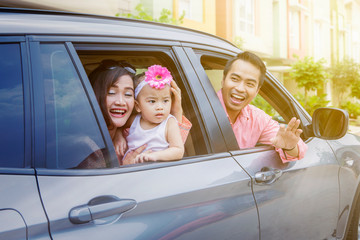 Parents and cute child looking out car windows