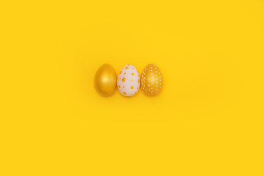 Easter golden decorated eggs on background. Minimal easter