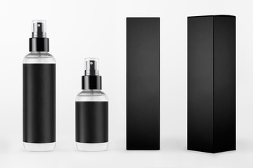 Mock up for design of packing cosmetics - different transparent dispenser bottles, black label, black paper boxes of different sides on white background.