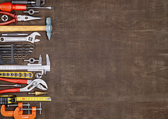 Tools in workshop. On table are tools for various types of construction and repair work on wood,...