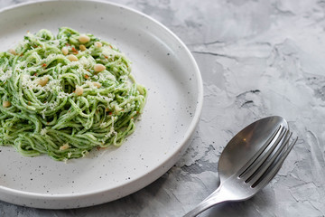 Green pasta with avocado, spinach and pine nuts