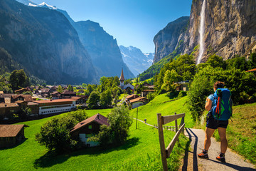 Woman hiker with backpack enjoying the view in Lauterbrunnen, Switzerland - 320250091