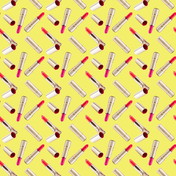 Seamless pattern of red lipstick in golden tube on yellow background isolated, shiny gold open and closed pink lipsticks, cosmetics accessory set, trendy make up wallpaper, beauty fashion art backdrop