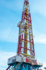 Oil and Gas Drilling Rig onshore dessert with dramatic cloudscape. Oil drilling rig operation on the oil platform in oil and gas industry