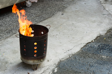 Ghost Money Burner burn the ghost money. Metal bucket and the fire burning.
