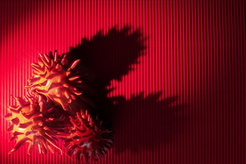 Abstract on the topic of contagious HIV / AIDS, Fluor coronavirus on a red background. Floating flu virus, cancer cells. Copy space.