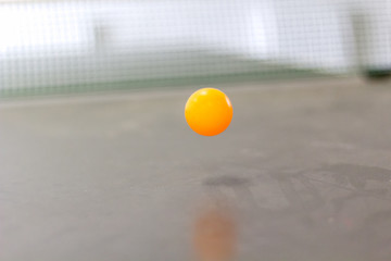 Ball in motion above table tennis table