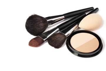 Loose powder, various makeup brushes. Makeup artist accessories isolated on white background. Products for perfect facial skin makeup.